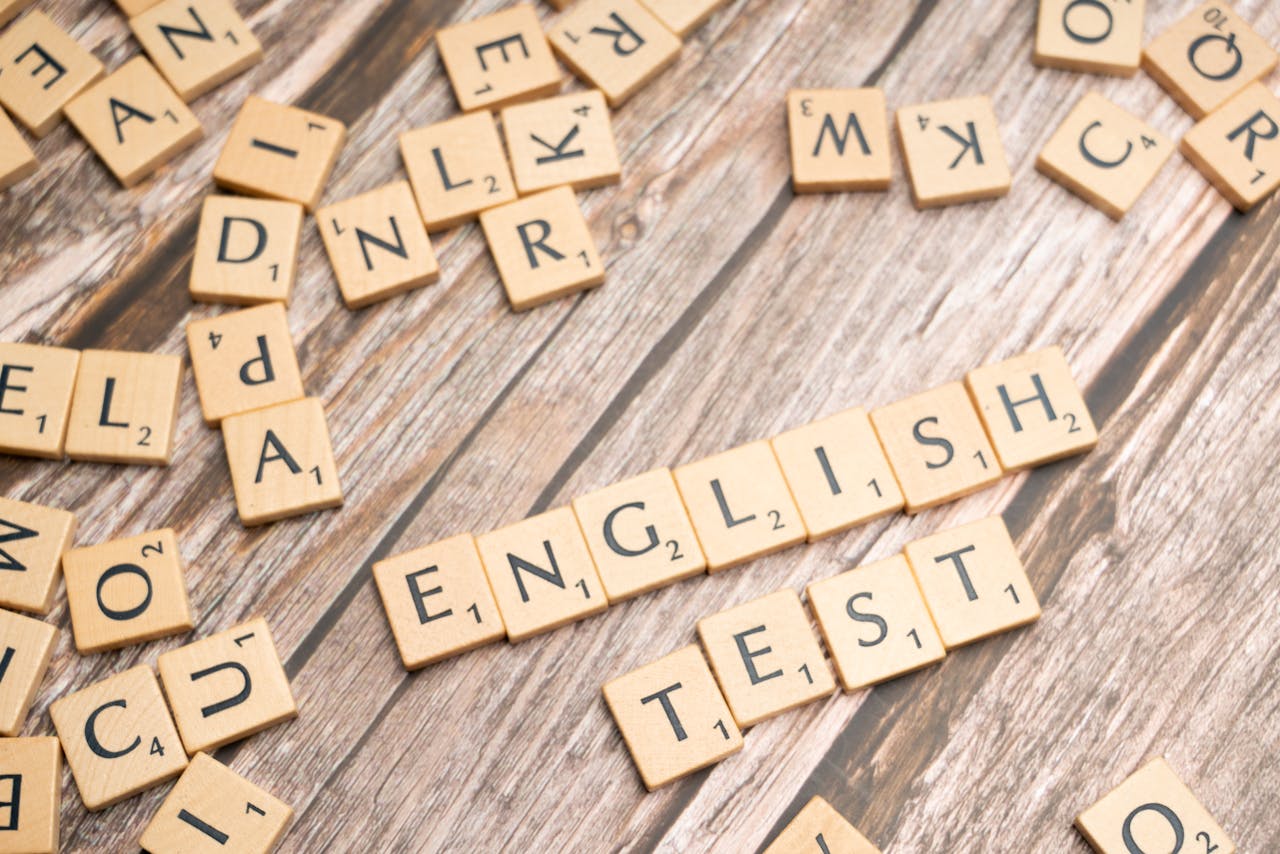 team-01 Wooden Scrabble tiles spelling out 'English Test' on a wooden background, ideal for language exam themes.